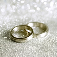 Two wedding rings surrounded by glitter